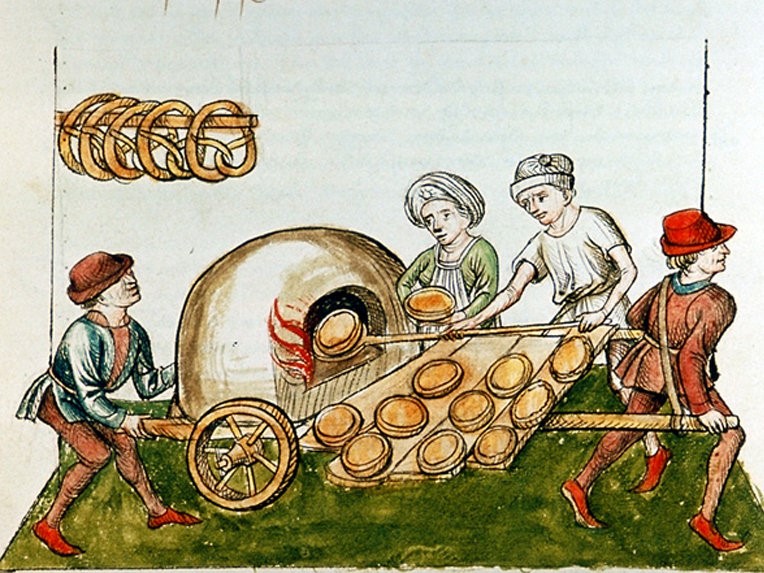 Pies being cooked by bakers in a pie oven/cart in medieval times.